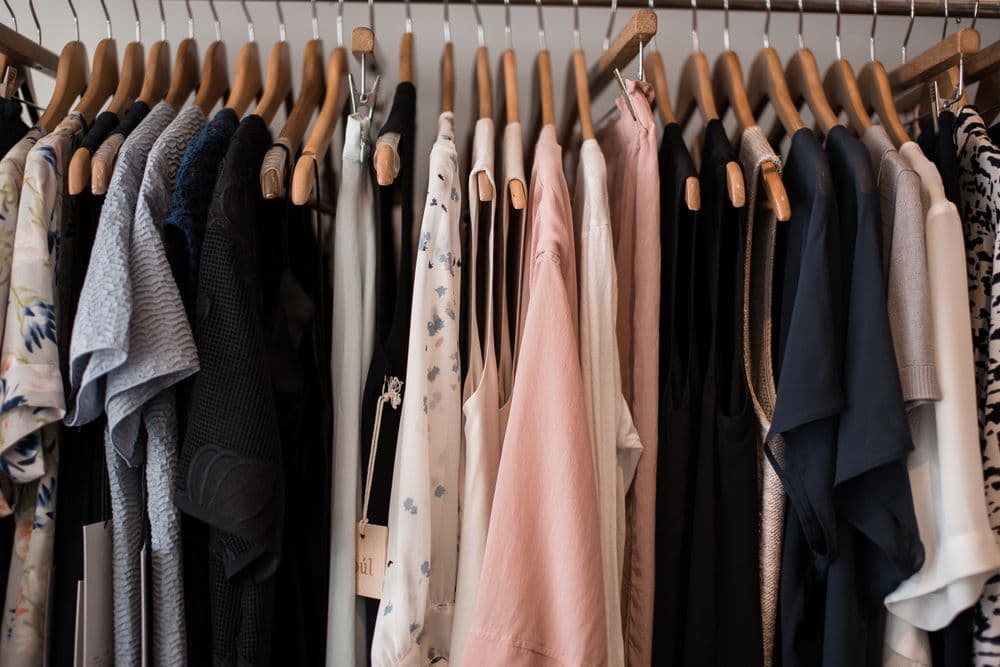 Curated designer ethnic outfits hanging in a boutique wardrobe
